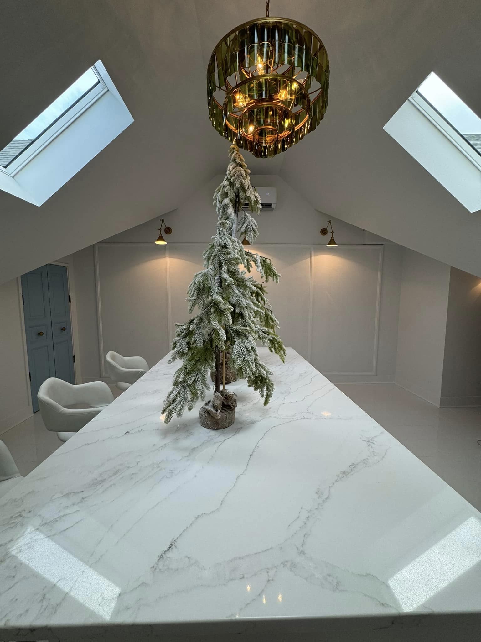 Marble waterfall island and brass chandelier under twin skylights in a converted attic office, Chattanooga TN area