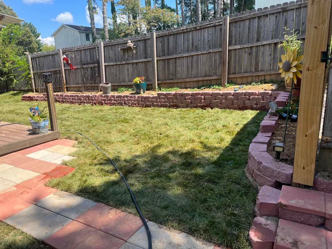 Backyard with stone retaining wall beds, paver walkway and new sod lawn, Chattanooga TN area