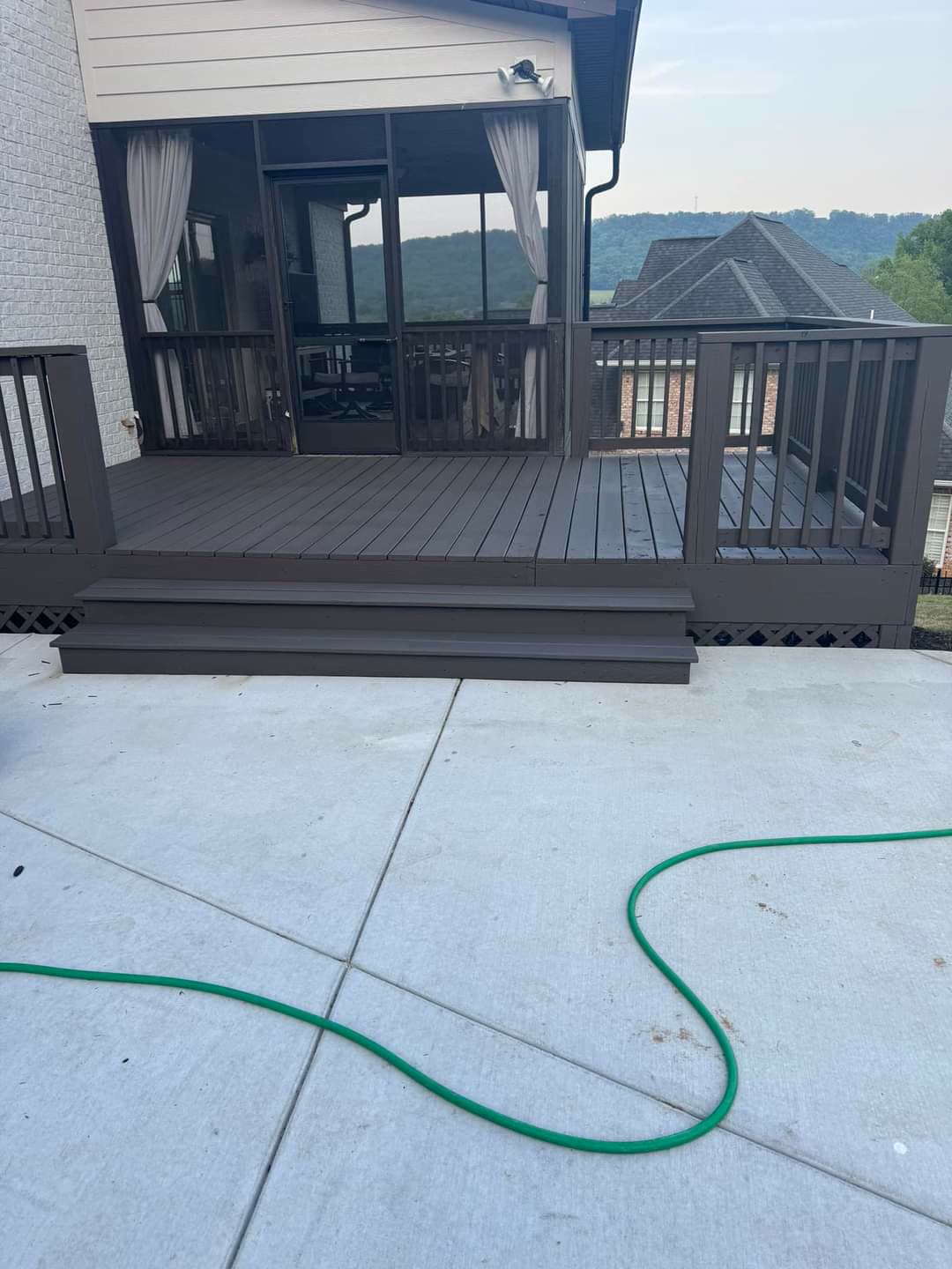 Grey composite deck with steps leading to a screened porch, mountain view, Chattanooga TN area
