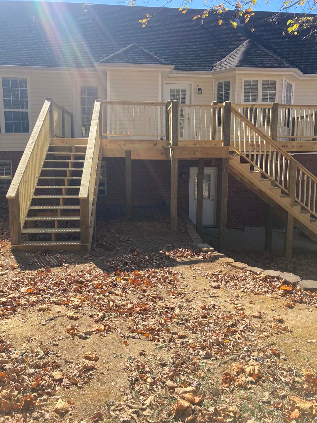 Elevated pressure-treated deck with two staircases on a brick home, Chattanooga TN area