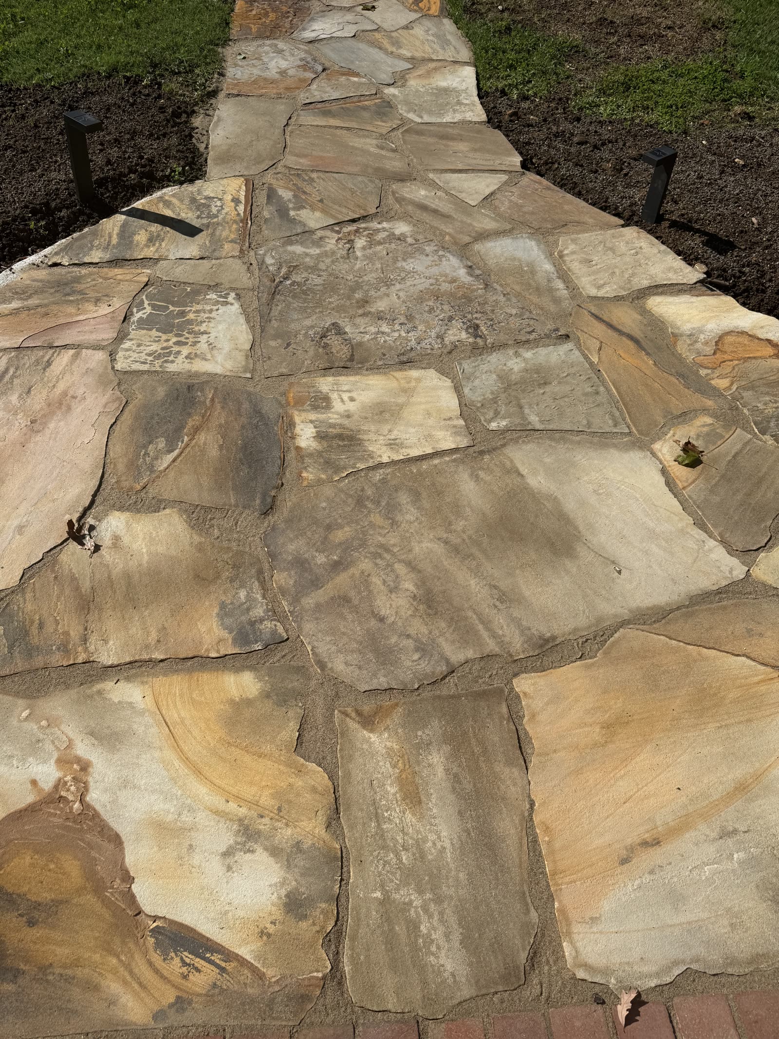 Hand-cut flagstone walkway with mortared joints running between planting beds, Chattanooga TN area
