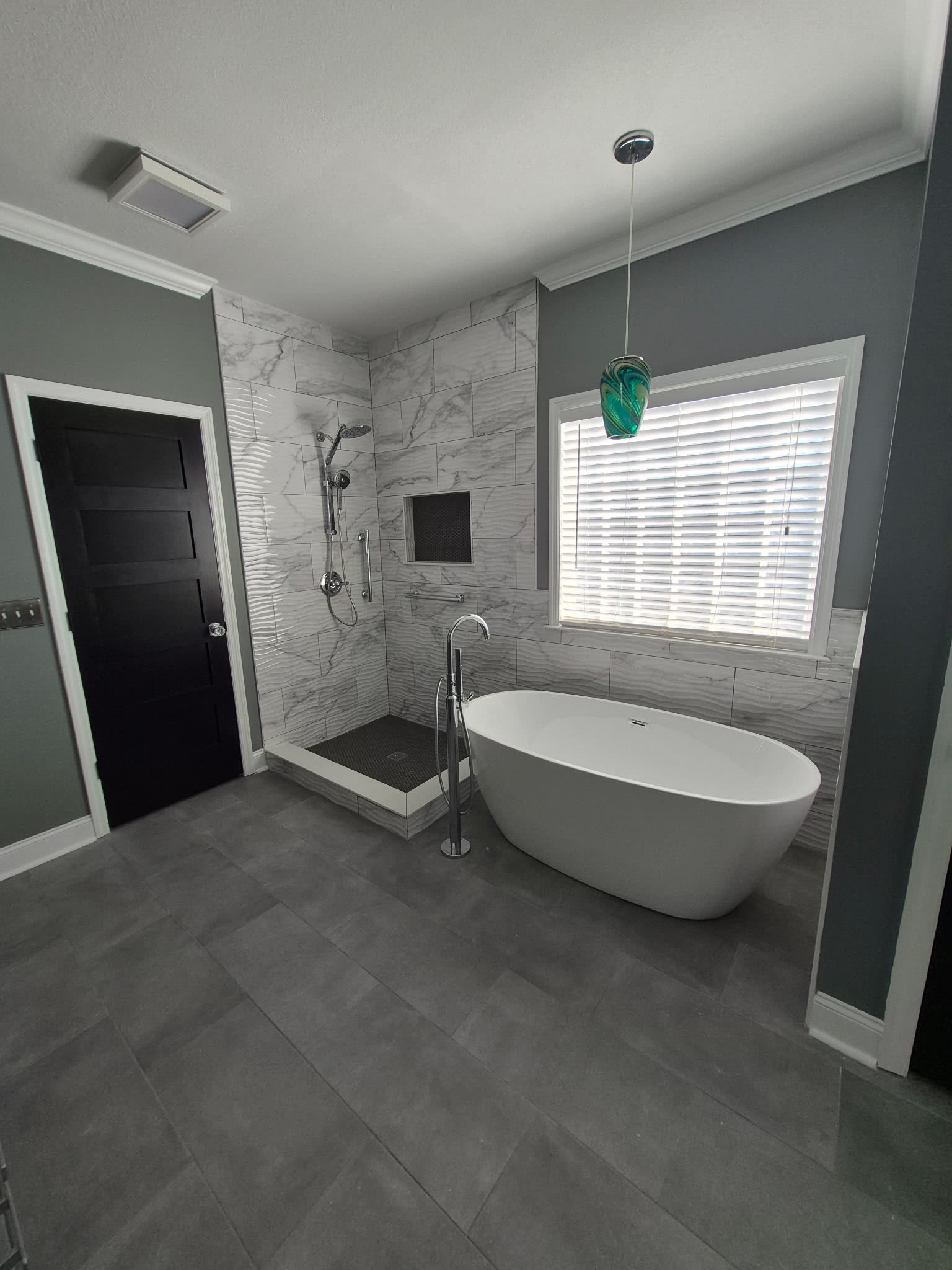 Walk-in tile shower with black penny-tile floor and built-in niche, master bathroom remodel, Chattanooga TN area
