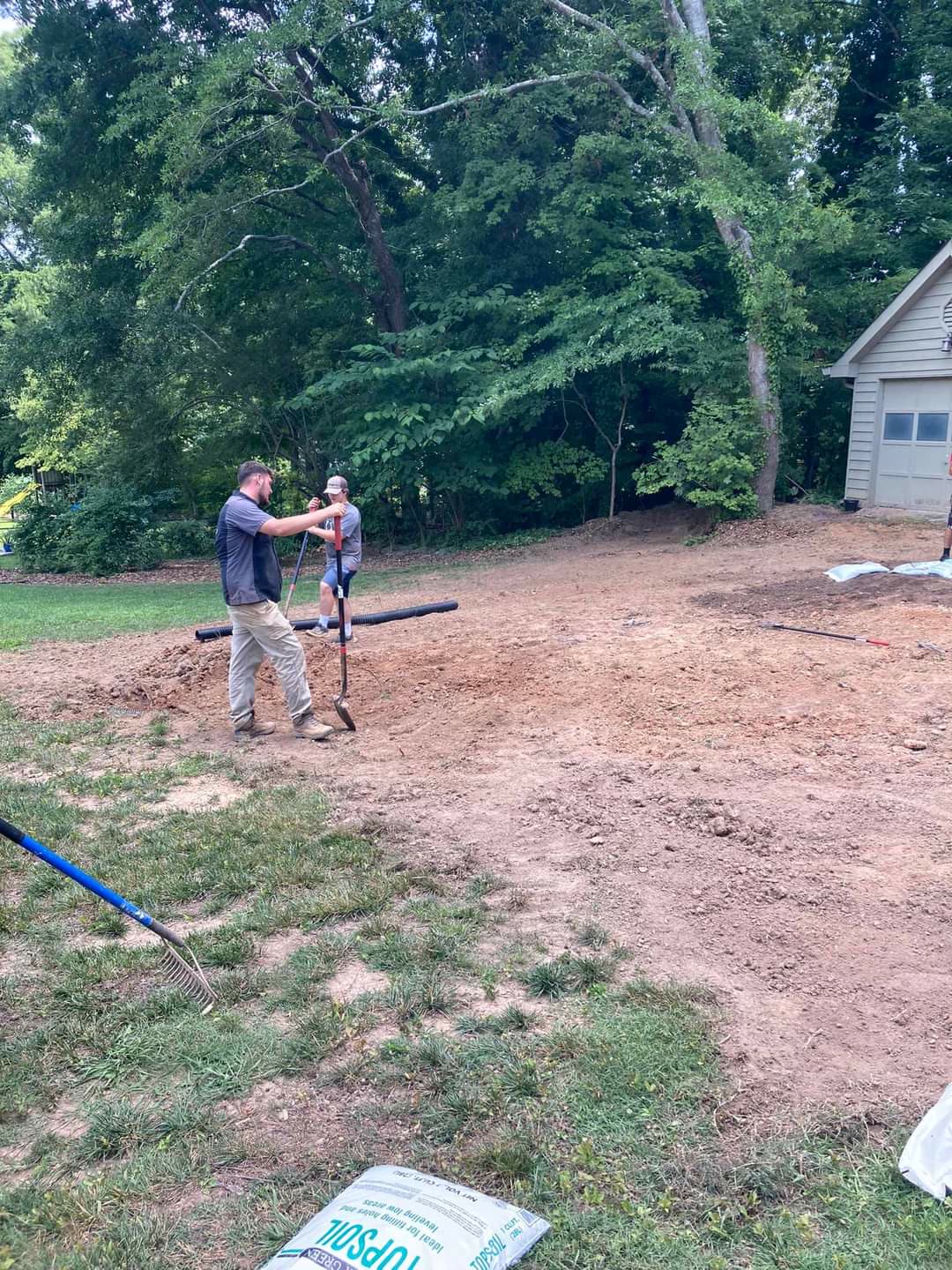 Crew grading a yard and spreading topsoil before sod, Chattanooga TN area